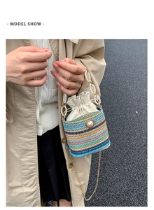 Detail of colorful woven bucket bag with pearl embellishment and acrylic chain handle