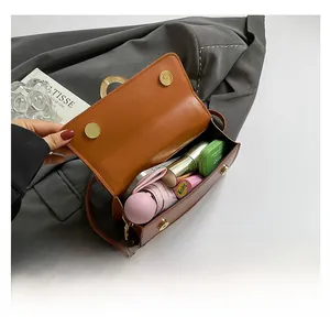 Interior view showing the storage capacity for umbrella and cosmetics in the brown bag