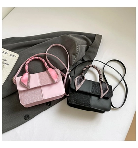 Detail of elegant pink and black crossbody bags with silk scarf wrapped handles