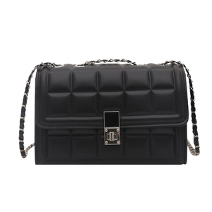 Detail of black quilted leather shoulder bag with silver square clasp and chain strap