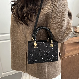 Chic black crossbody bag with white star pattern and braided handle for women