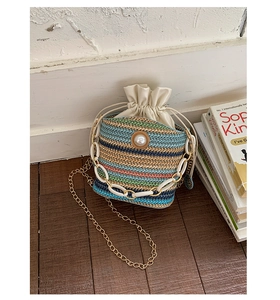 Detail of colorful woven straw bucket bag with pearls and stylish chunky chain strap