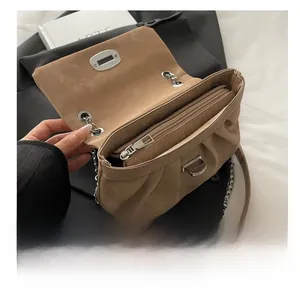 Detail shot of the khaki shoulder bag showing interior compartment and smooth silver zipper