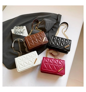 Detailed view of quilted square bags in four colors with gold metal flip cover trim