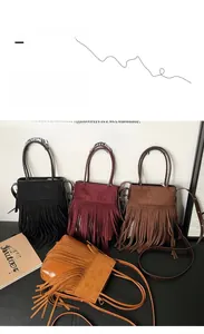 Detail view of four bohemian tassel bags in black, burgundy, brown, and mustard yellow