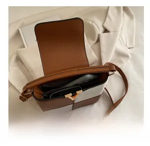 Internal view of two-tone contrast bag showing capacity for a mobile phone and accessories
