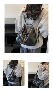 Détail du sac hobo en cuir noir avec fermetures éclair argentées et glands élégants