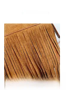 Detail of tan suede handbag featuring dense long fringe in a bohemian retro style