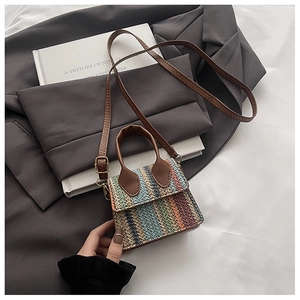 Detail of colorful rainbow zigzag woven pattern on mini straw crossbody bag with gold hardware