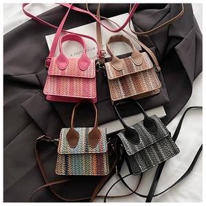 Detail view of mini woven straw crossbody bags in four colors with PU handles