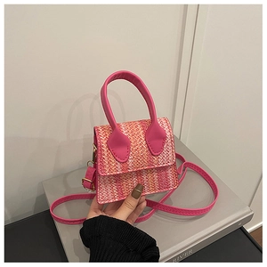 Close-up of pink and orange woven mini crossbody bag with gold hardware detail