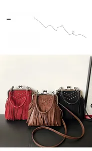 Detail of vintage suede doctor bags with metal rivets, tassels, and frame closure