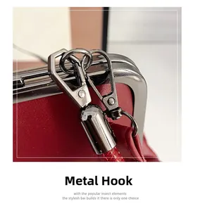 Close-up of gunmetal hardware hook and textured red leather on stylish shoulder bag