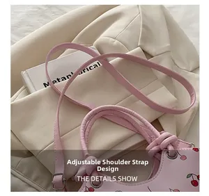 Detail view of the pink cherry tote bag showing the adjustable silver metal buckle strap
