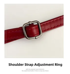 Detail of red leather shoulder strap with adjustable silver square metal buckle