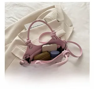 Detail showing pink bucket bag interior with cherry print and twist rope handle