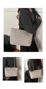Detail of tweed checkered texture and golden chain strap on stylish shoulder tote bag