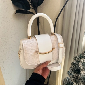 Minimalist white square handbag with snakeskin texture and gold metal accent strap