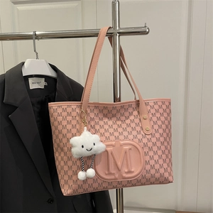 Pink PU tote bag detail with M letter print and fluffy cloud pendant accessory