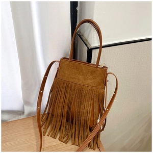 Detailed view of brown suede bohemian shoulder bag with long vintage fringe tassels