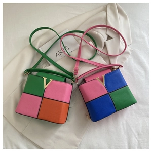 Detail of color-block leather crossbody bags with metal V logo on textured crossgrain finish
