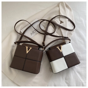 Detail view of square crossbody bags with golden V hardware and checkerboard pattern
