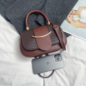 Brown leather square handbag with woven texture flap and crescent gold hardware accent