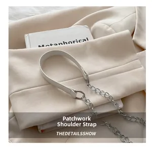 Détail de la bandoulière en cuir grainé et chaîne métallique d'un sac à main élégant
