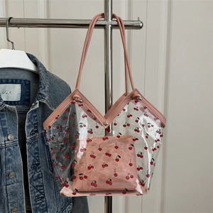Transparent PVC tote bag with red cherry print and pink faux leather trim on denim jacket
