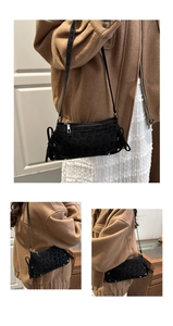 Close-up of black leopard print shoulder bag with metal zipper and drawstring details