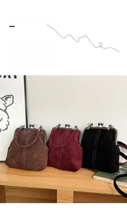 Retro kiss-lock handbags in brown, burgundy, and black with suede finish and stitching