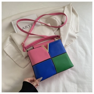 Detail of tricolor拼接 leather bag with pink blue green panels and gold V hardware
