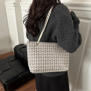 Chic plaid tweed tote bag with chain strap shown on model for daily commuting style