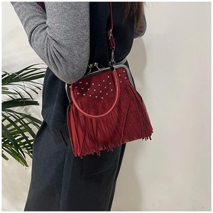 Red retro fringe handbag with metal clasp and rivet details worn by model on shoulder