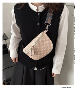 Detail of pink crossbody chest bag with M-logo pattern and patterned fabric strap