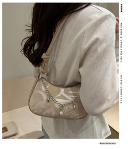 Detail of PU leather shoulder bag with artistic letters and heart pearl chain