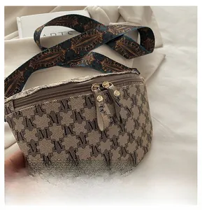 Detail of vintage patterned crossbody bag with dual metal zippers and jacquard strap