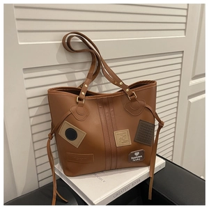 Brown vintage faux leather tote bag with stylish heart patches and long shoulder straps