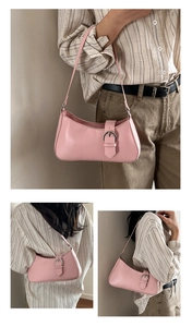 Detail shot of a soft pink French baguette bag with shiny silver metal buckle and strap