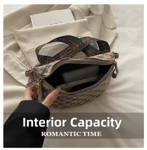 Internal capacity of retro patterned crossbody bag showing space for phone and wallet