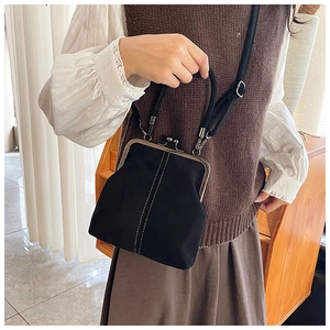 Detail of vintage black matte doctor bag featuring silver metal clasp and top handle