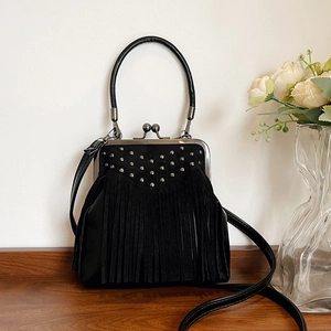 Fashionable black leather doctor bag with vintage metal rivets and long fringe details