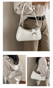 Detail of white vintage hobo bag featuring matte leather and a silver buckle accent