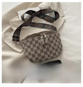 Detailed size comparison of a vintage monogram crossbody bag with embroidered strap