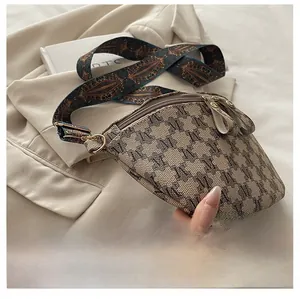 Close-up of retro jacquard chest bag with patterned strap and dual zipper detail