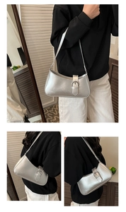 French style silver metallic shoulder bag with buckle detail shown on a female model