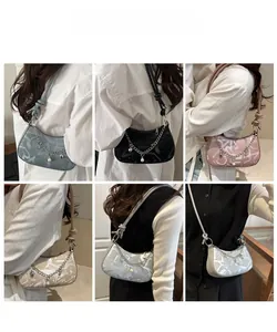 Detail shots of crescent moon shoulder bag with abstract prints and pearl chain