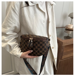 Detail of vintage brown monogram crossbody bag with colorful bohemian wide shoulder strap