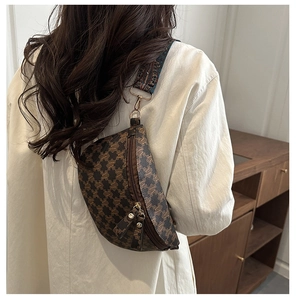Detail of vintage brown checkerboard chest bag with M-pattern leather and jacquard strap