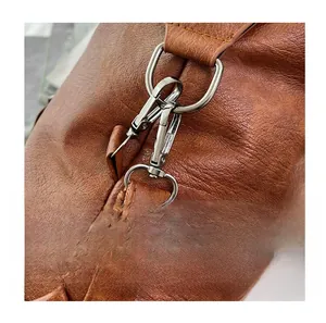 Macro shot of gunmetal hardware buckles and soft pebbled leather on a brown tote bag